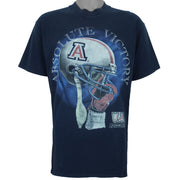 2000s vintage NCAA University of Arizona Wildcats football helmet T-Shirt. Dark blue in color with "Absolute Victory" spell-out on front and "We Came, We Saw, We Kicked Butt" on back. Fits Medium in size and in excellent condition.