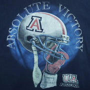 2000s vintage NCAA University of Arizona Wildcats football helmet T-Shirt. Dark blue in color with "Absolute Victory" spell-out on front and "We Came, We Saw, We Kicked Butt" on back. Fits Medium in size and in excellent condition.