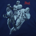 1990s vintage Budweiser single stitch T-Shirt by Hanes Beefy-T. Blue in color with three players and "Bud, King of Beers" small spell-out on front, X-Large in size and is in excellent condition.