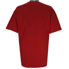 2004 vintage NCAA University of Nebraska-Lincoln Cornhuskers spell-out Gildan T-Shirt. Red in color with "Rise of the Machine, West Coast Offense" text and football player graphic on front by Art-Fx Collectors Edition. X-Large in size and in excellent condition.