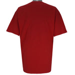 2004 vintage NCAA University of Nebraska-Lincoln Cornhuskers spell-out Gildan T-Shirt. Red in color with "Rise of the Machine, West Coast Offense" text and football player graphic on front by Art-Fx Collectors Edition. X-Large in size and in excellent condition.