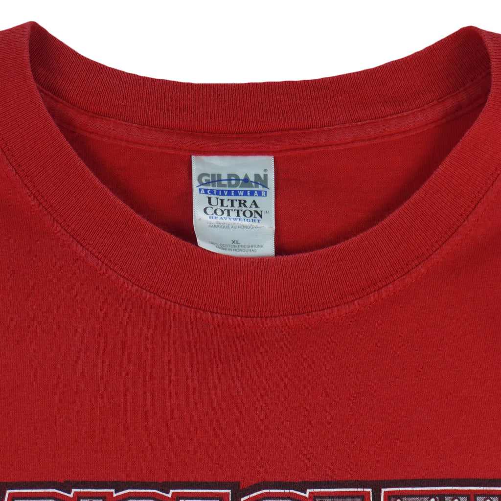 2004 vintage NCAA University of Nebraska-Lincoln Cornhuskers spell-out Gildan T-Shirt. Red in color with "Rise of the Machine, West Coast Offense" text and football player graphic on front by Art-Fx Collectors Edition. X-Large in size and in excellent condition.