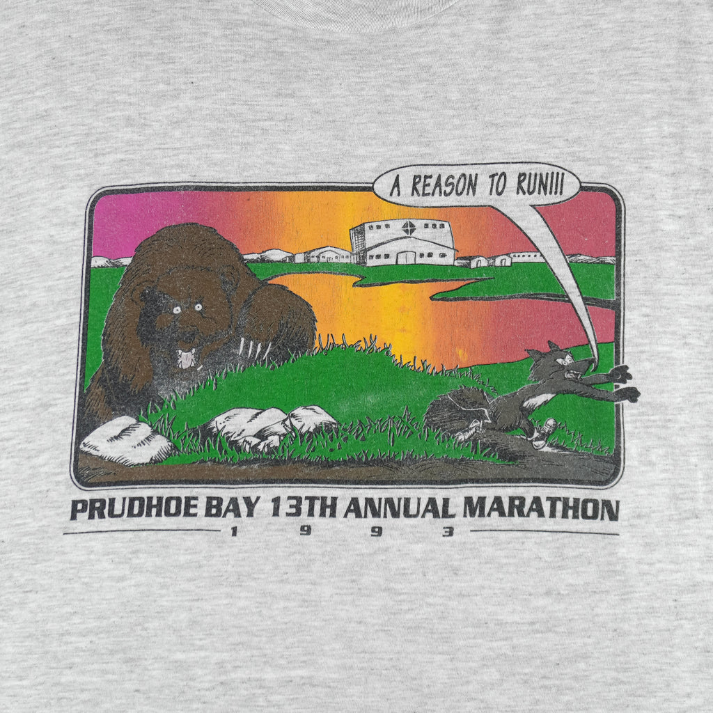 1993 vintage Prudhoe Bay 13th Annual Marathon T-Shirt by Hanes. Light grey in color with animal cartoon printed graphic on front, tagged size Large and is in excellent condition.