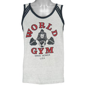1990s vintage World Gym, Santa Monica USA sleeveless workout shirt. Grey in color with black trim, has a big printed graphic of the gorilla logo on front and back, fits Medium in size, and is in excellent condition.