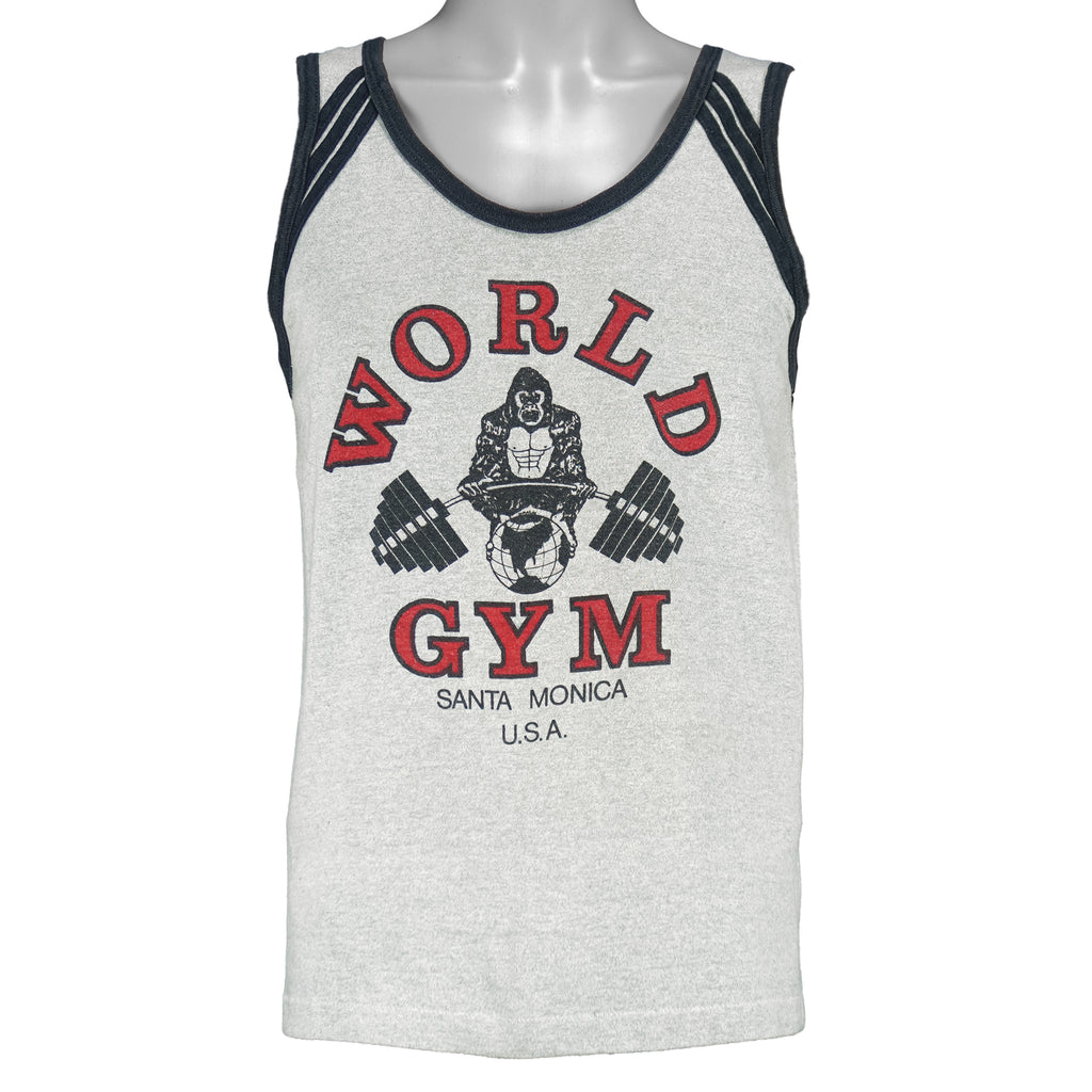 1990s vintage World Gym, Santa Monica USA sleeveless workout shirt. Grey in color with black trim, has a big printed graphic of the gorilla logo on front and back, fits Medium in size, and is in excellent condition.