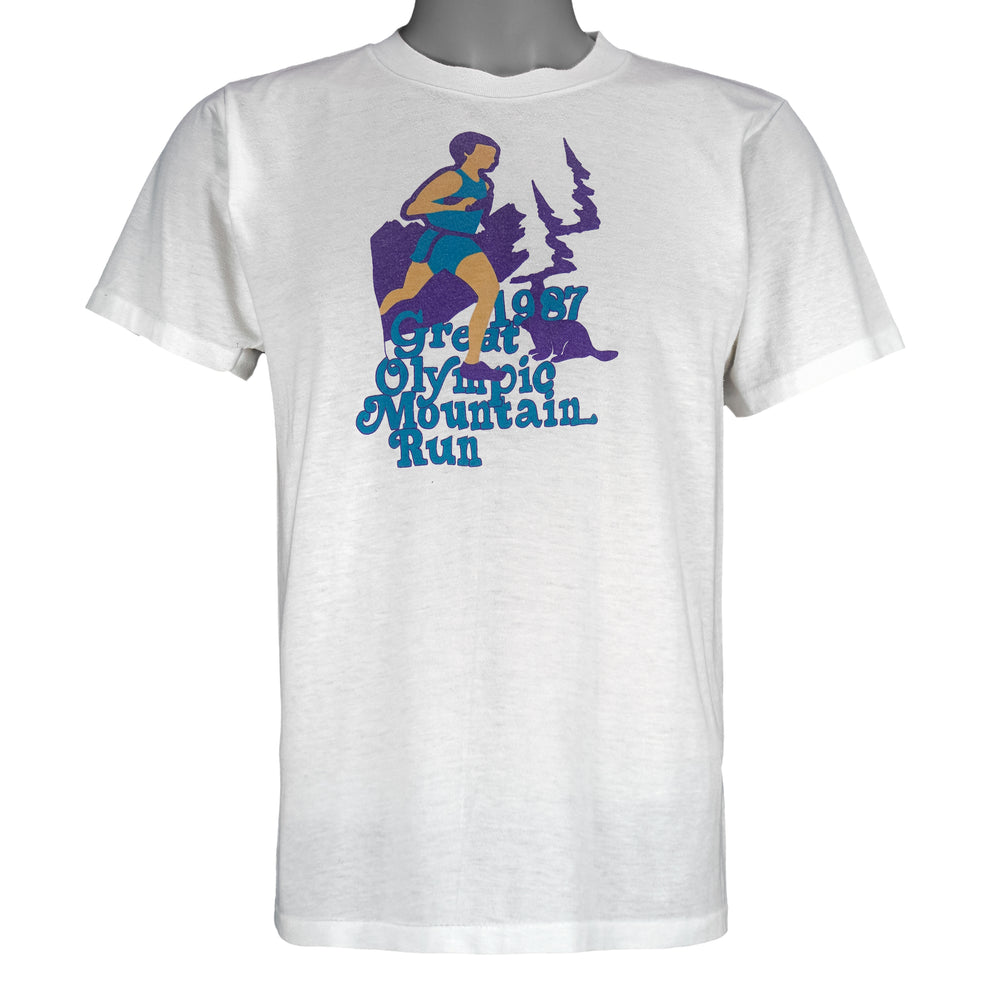 1987 vintage Great Olympic Mountain Run T-Shirt by My Shirt is Made in the USA. White in color with printed graphic on front, tagged size Large, and is in excellent condition.