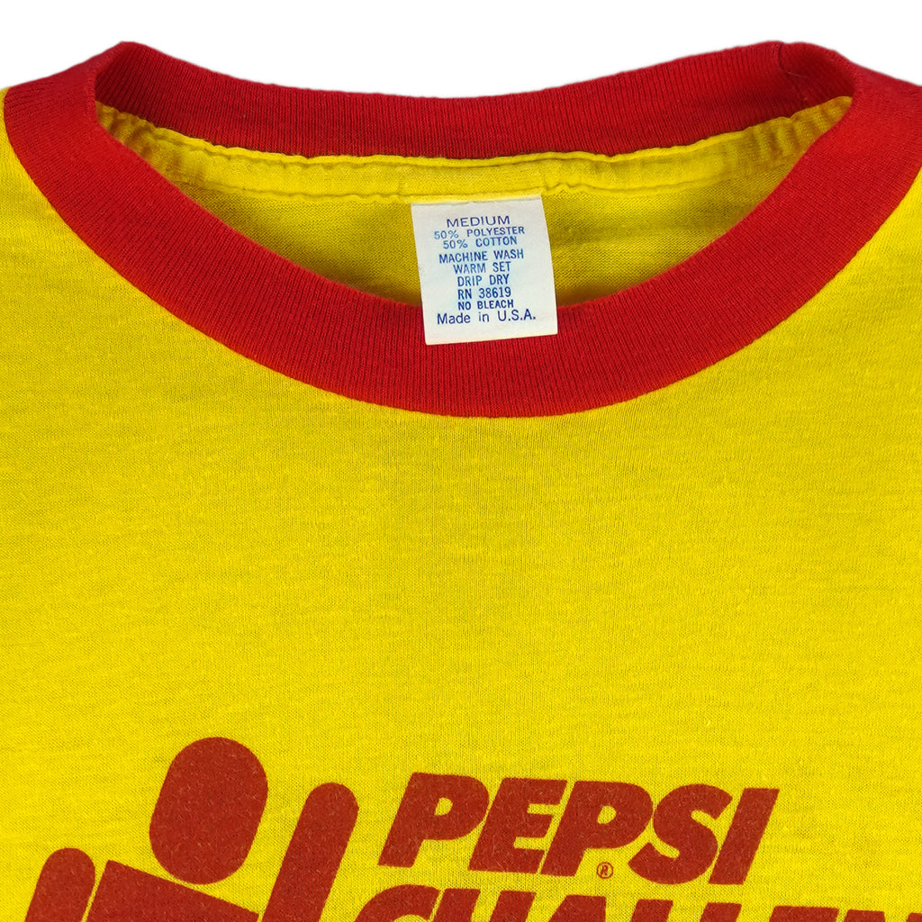1980s vintage Pepsi Challenge: 10,000 Meter Series ringer T-Shirt. Yellow in color with red trim, Campus Life spell-out on back, tagged size Medium and is in excellent condition.