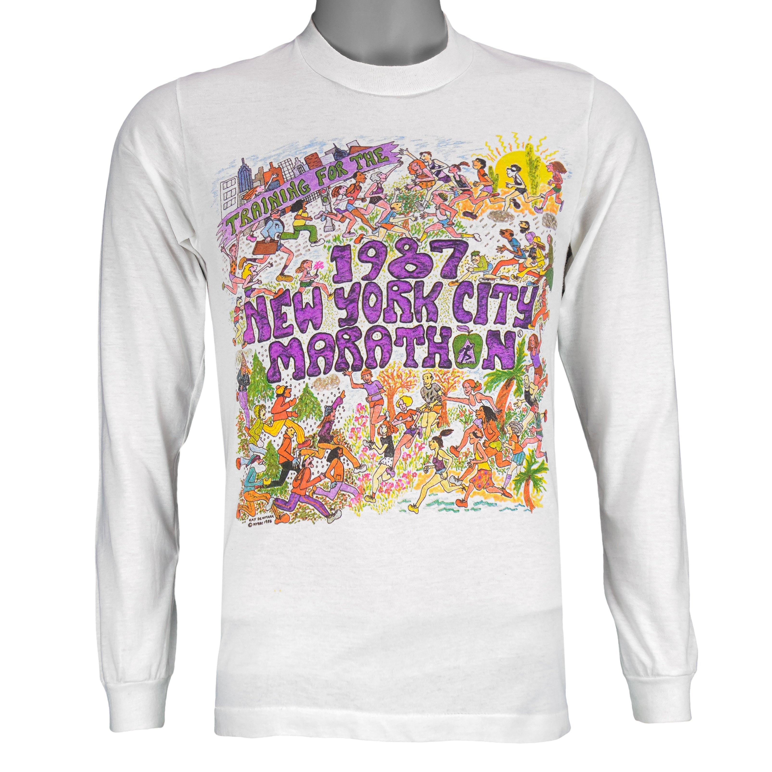 1987 vintage I Trained for the New York City Marathon Long Sleeve Shirt. White in color with original artwork by Kay Denmark on front, fits Small in size and is in excellent condition.