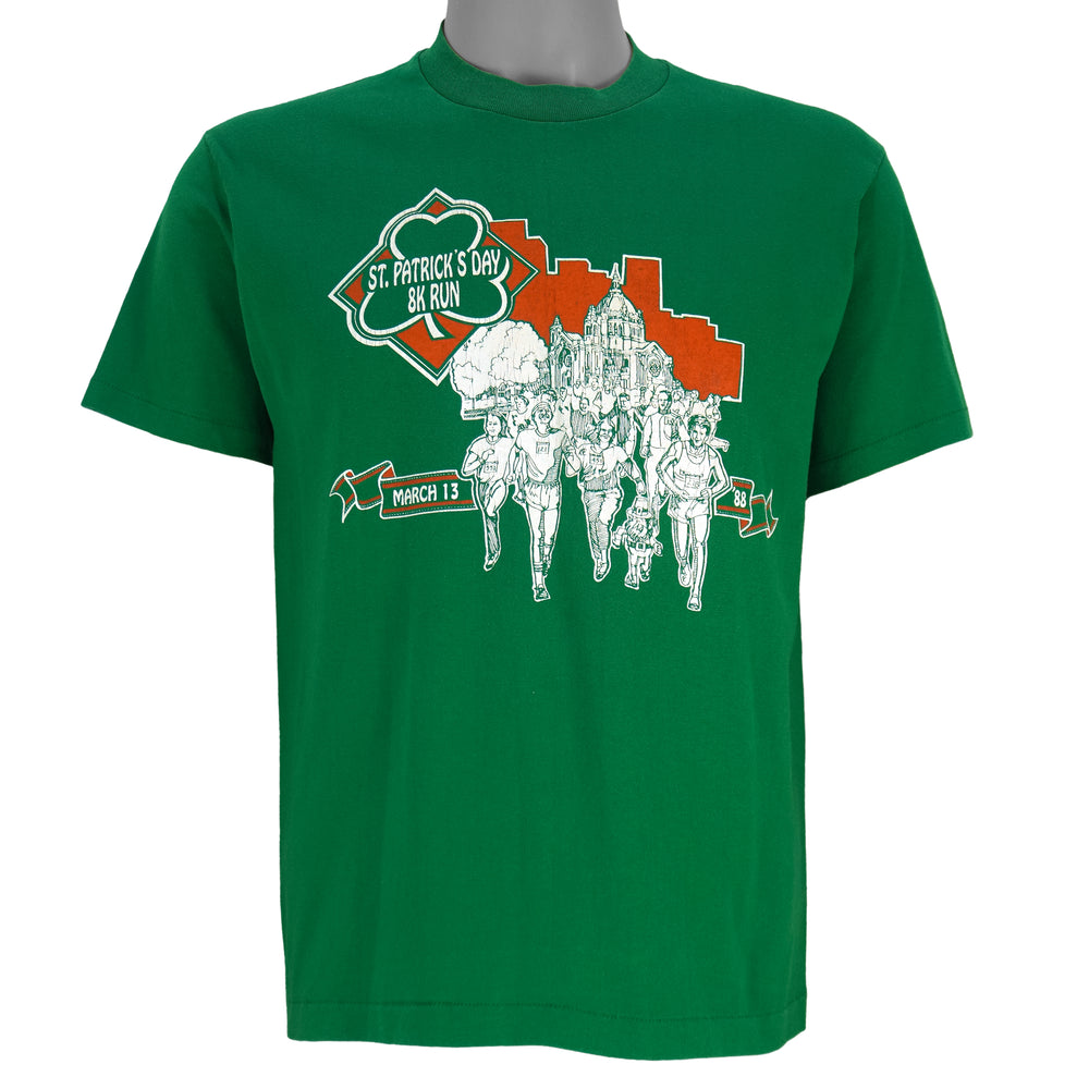1988 vintage St. Patricks' Day 8K Run, March 13 in Saint Paul Minnesota, T-Shirt by Tee Jays. Green in color with runners and Irish clover on front and sponsors logos on back, tagged size Large and is in excellent condition.