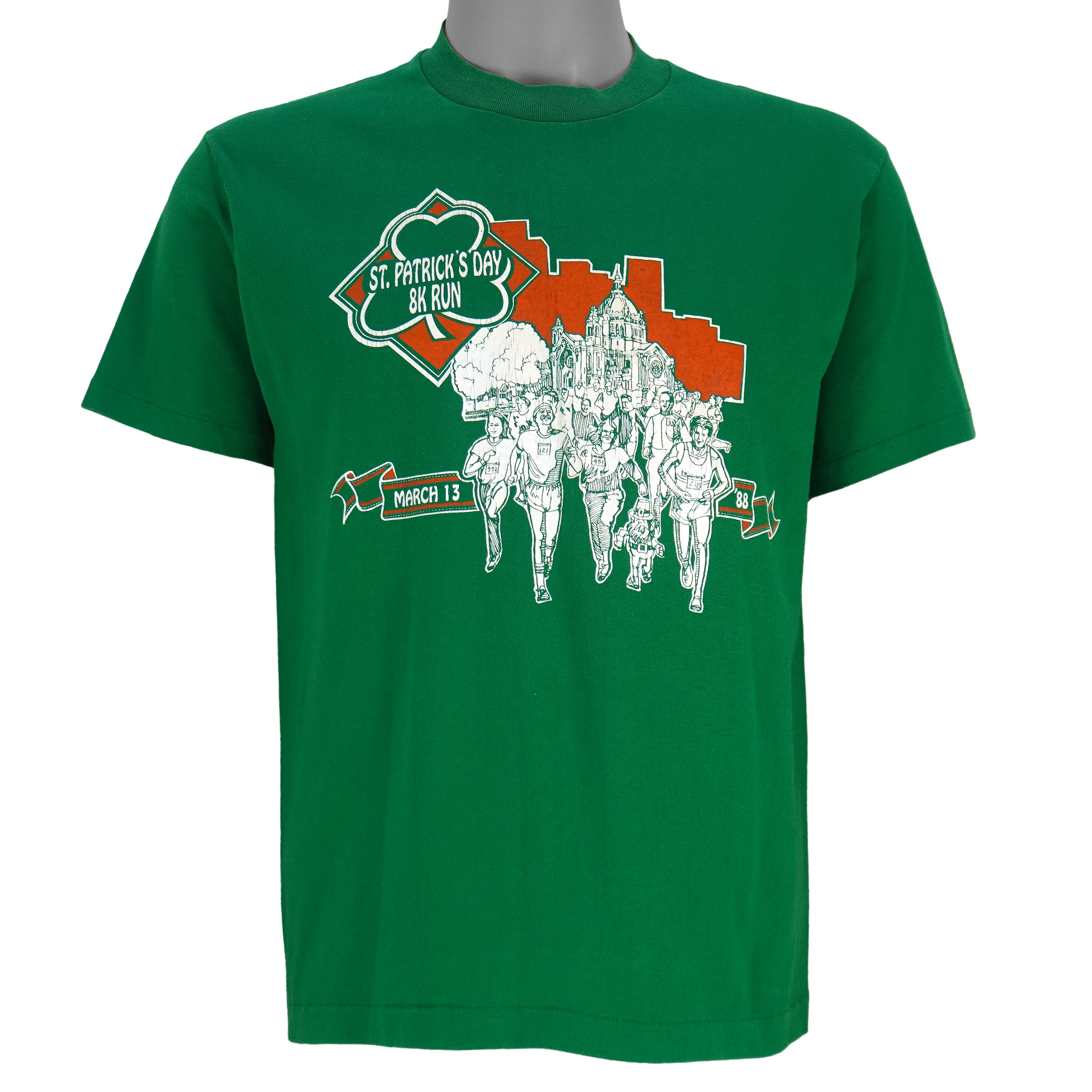 1988 vintage St. Patricks' Day 8K Run, March 13 in Saint Paul Minnesota, T-Shirt by Tee Jays. Green in color with runners and Irish clover on front and sponsors logos on back, tagged size Large and is in excellent condition.