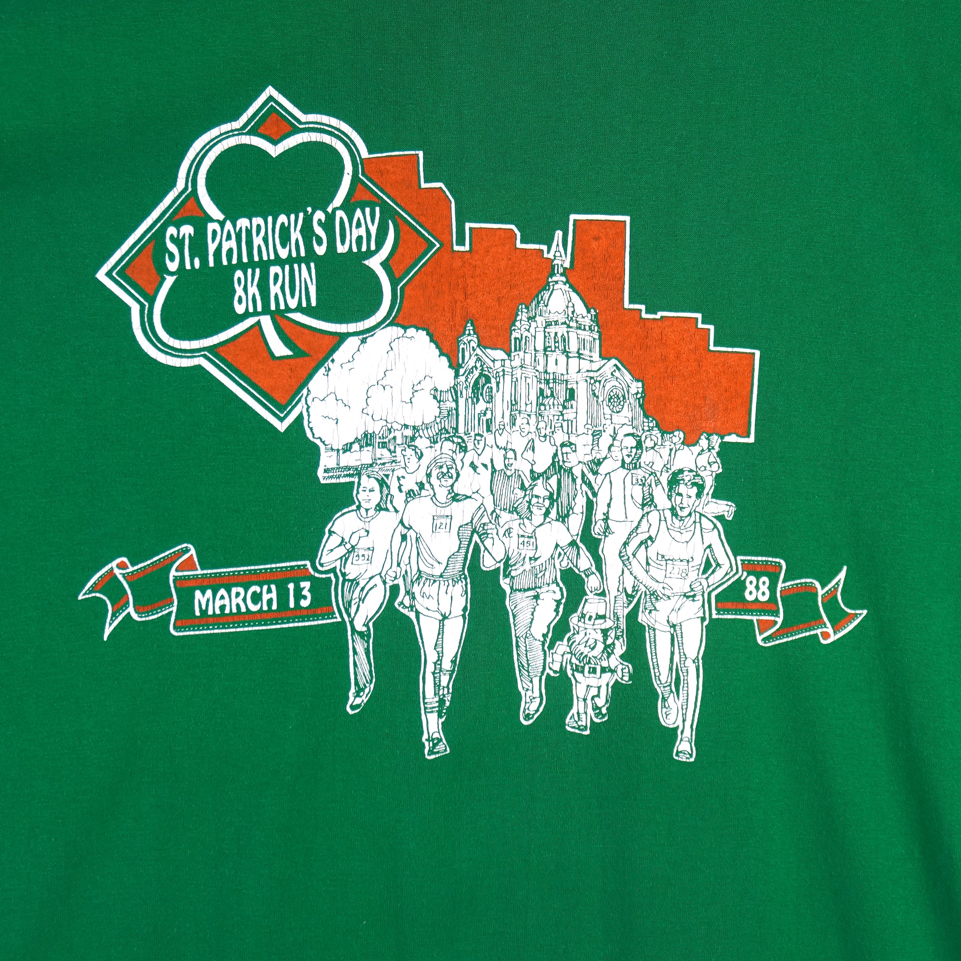 1988 vintage St. Patricks' Day 8K Run, March 13 in Saint Paul Minnesota, T-Shirt by Tee Jays. Green in color with runners and Irish clover on front and sponsors logos on back, tagged size Large and is in excellent condition.