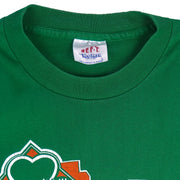 1988 vintage St. Patricks' Day 8K Run, March 13 in Saint Paul Minnesota, T-Shirt by Tee Jays. Green in color with runners and Irish clover on front and sponsors logos on back, tagged size Large and is in excellent condition.