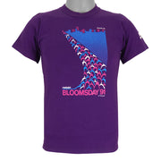 1991 vintage Bloomsday, Spokane Washington, Finisher T-Shirt by Jerzees. Purple in color with abstract people and skyline graphic printed on front and Nike insignia on left sleeve, tagged size Small and is in excellent condition.