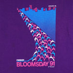 1991 vintage Bloomsday, Spokane Washington, Finisher T-Shirt by Jerzees. Purple in color with abstract people and skyline graphic printed on front and Nike insignia on left sleeve, tagged size Small and is in excellent condition.