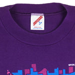 1991 vintage Bloomsday, Spokane Washington, Finisher T-Shirt by Jerzees. Purple in color with abstract people and skyline graphic printed on front and Nike insignia on left sleeve, tagged size Small and is in excellent condition.