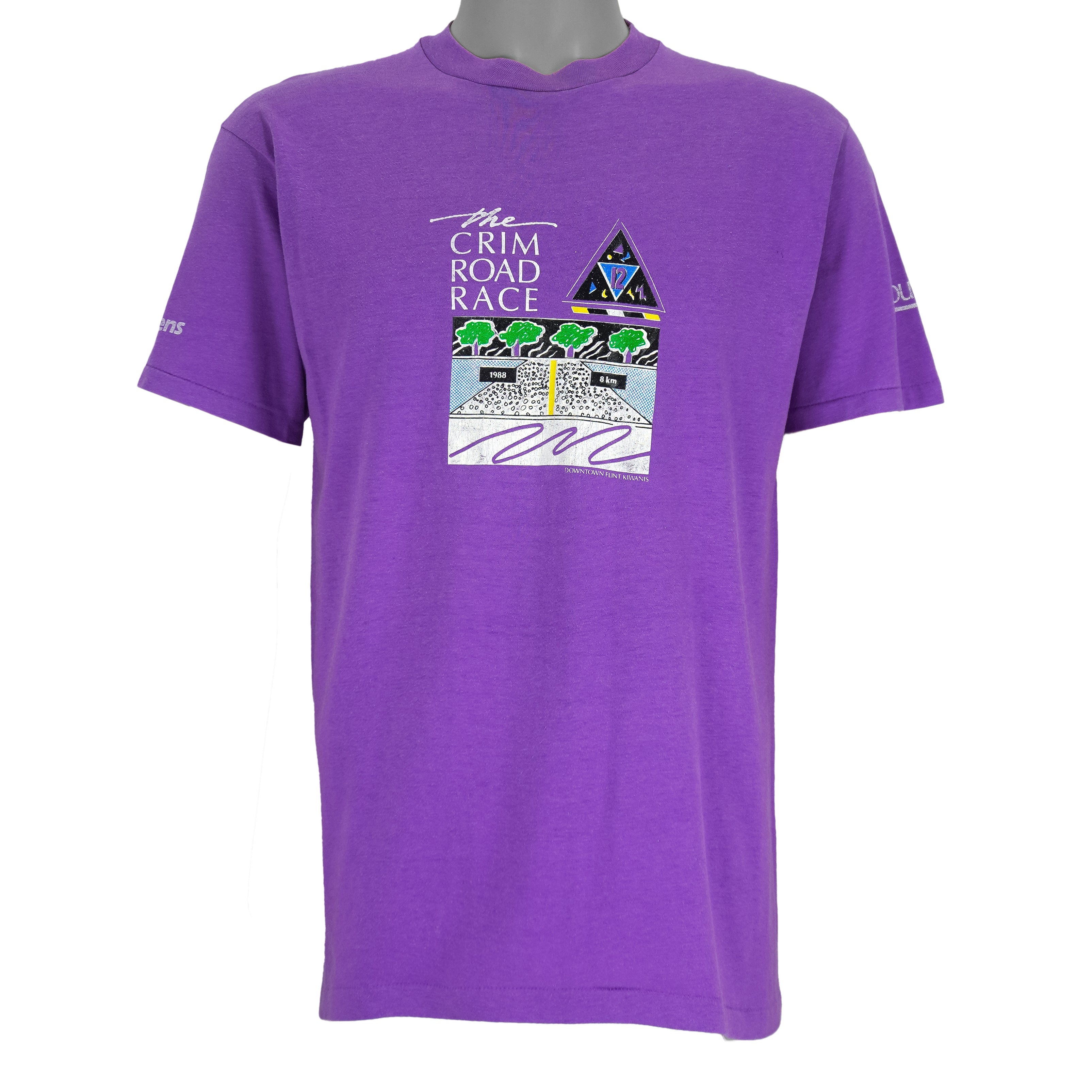 1988 vintage Flint Michigan 8 KM Crim Road Race T-Shirt by Hanes. Purple in color with printed&nbsp; graphics on front and back, tagged size Large and is in excellent condition.
