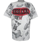 NCAA (TSI) - Nebraska Huskers All Over Print T-Shirt 1990s X-Large Vintage Retro Football