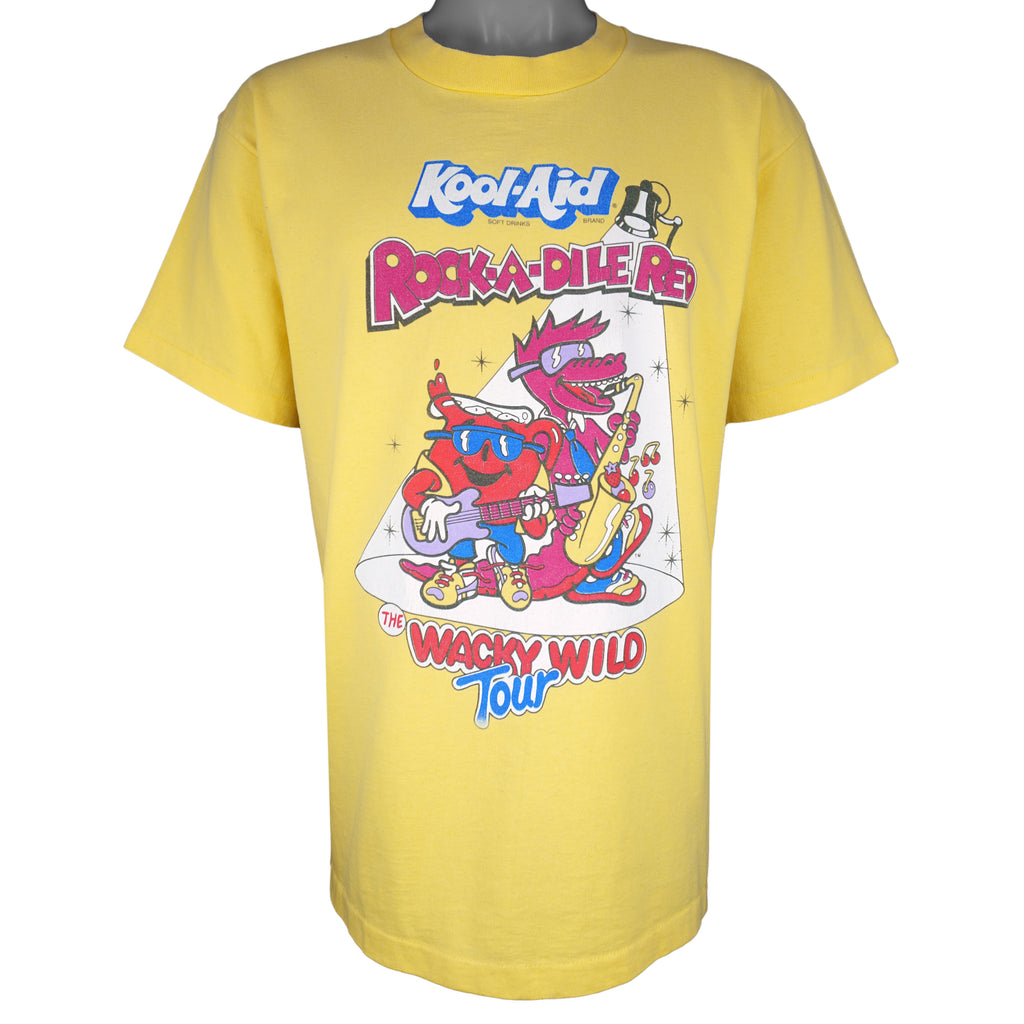 A vintage yellow Kool-Aid Rock-A-Dile Red Whacky Wild Tour t-shirt with a graphic print of Kool-Aid Man and a dinosaur.