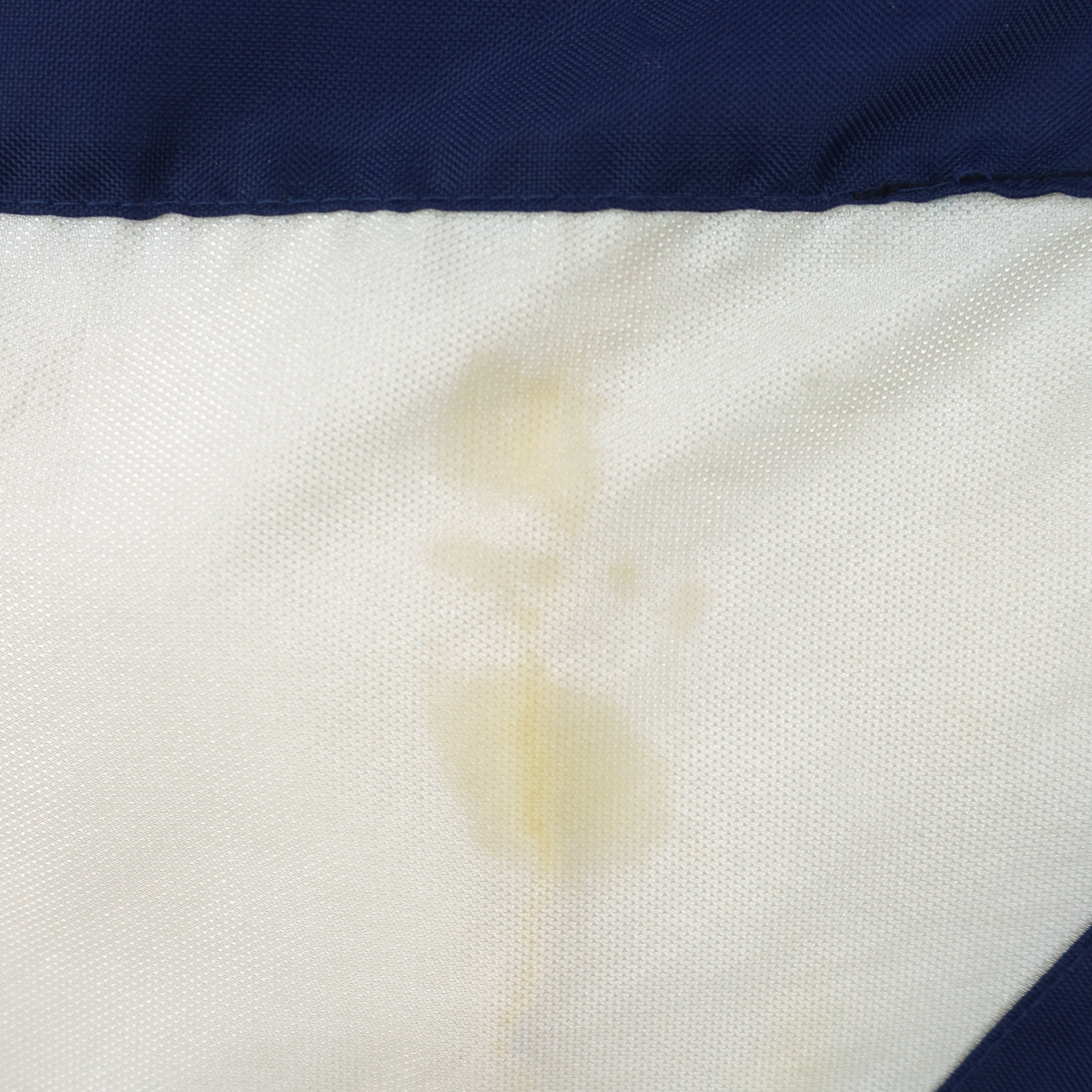 Michigan Wolverines jacket white panel discoloration condition detail
