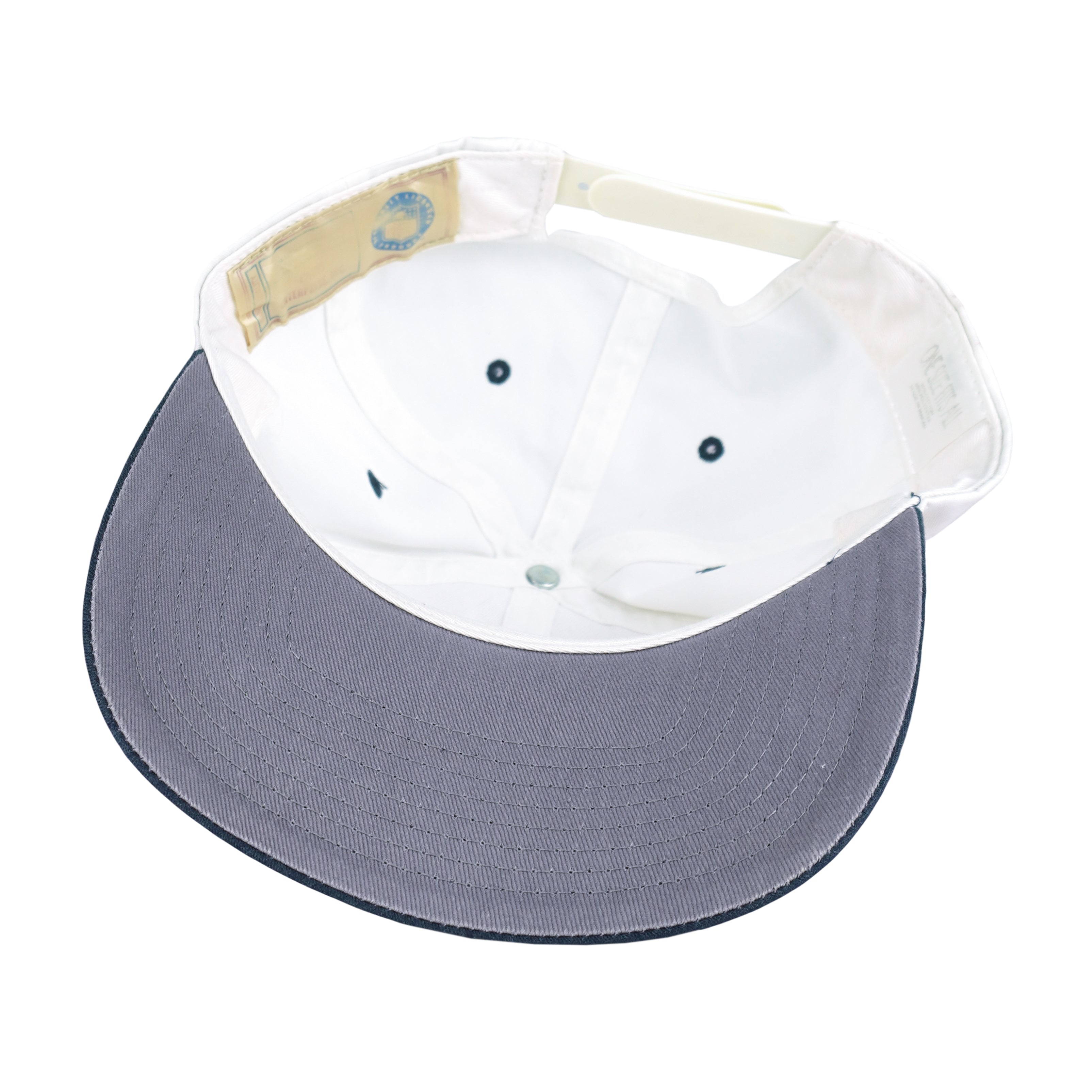 Interior white sweatband and gray underside of the hat brim