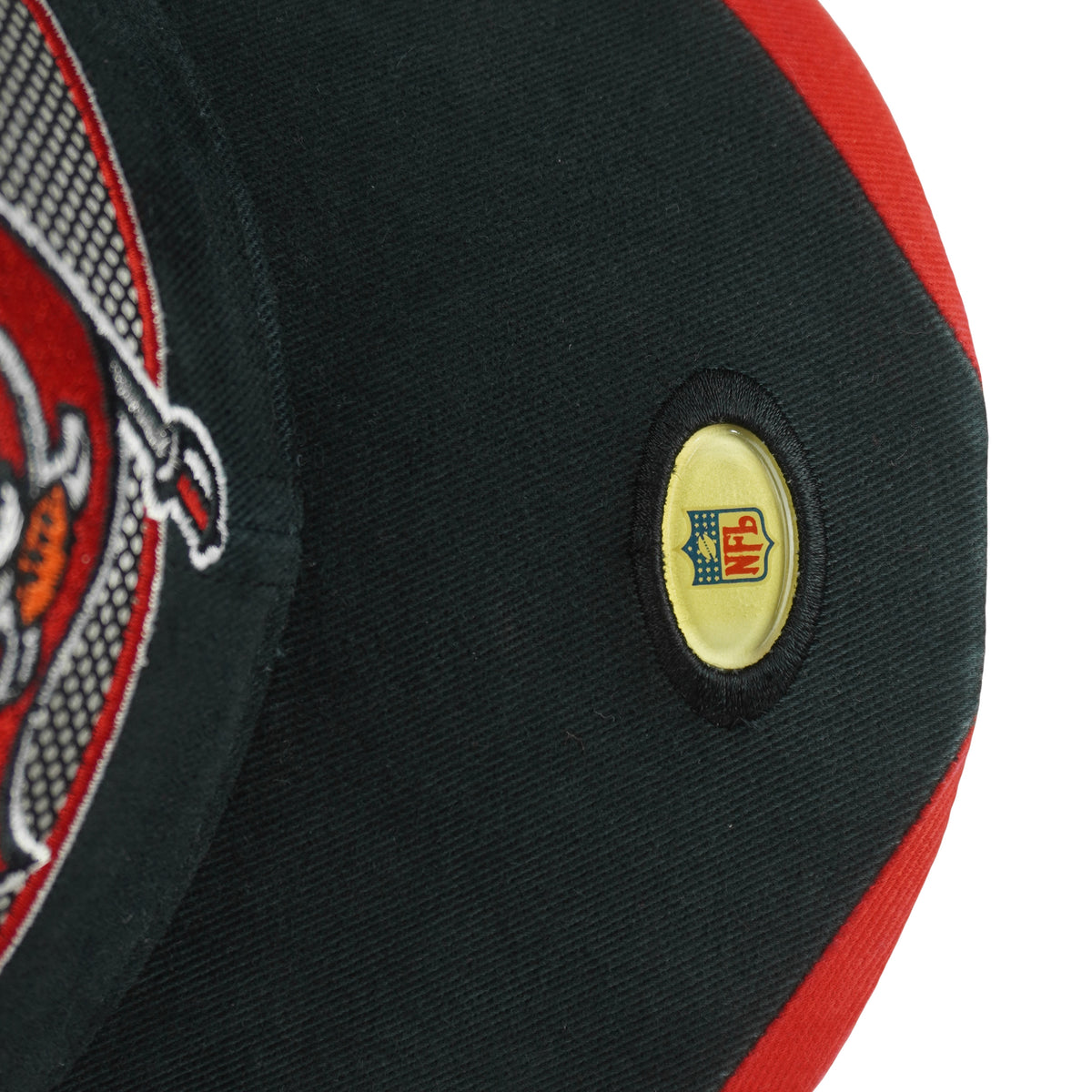 Round NFL emblem attached to the black hat brim