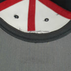Small mark visible on the gray underside of the brim
