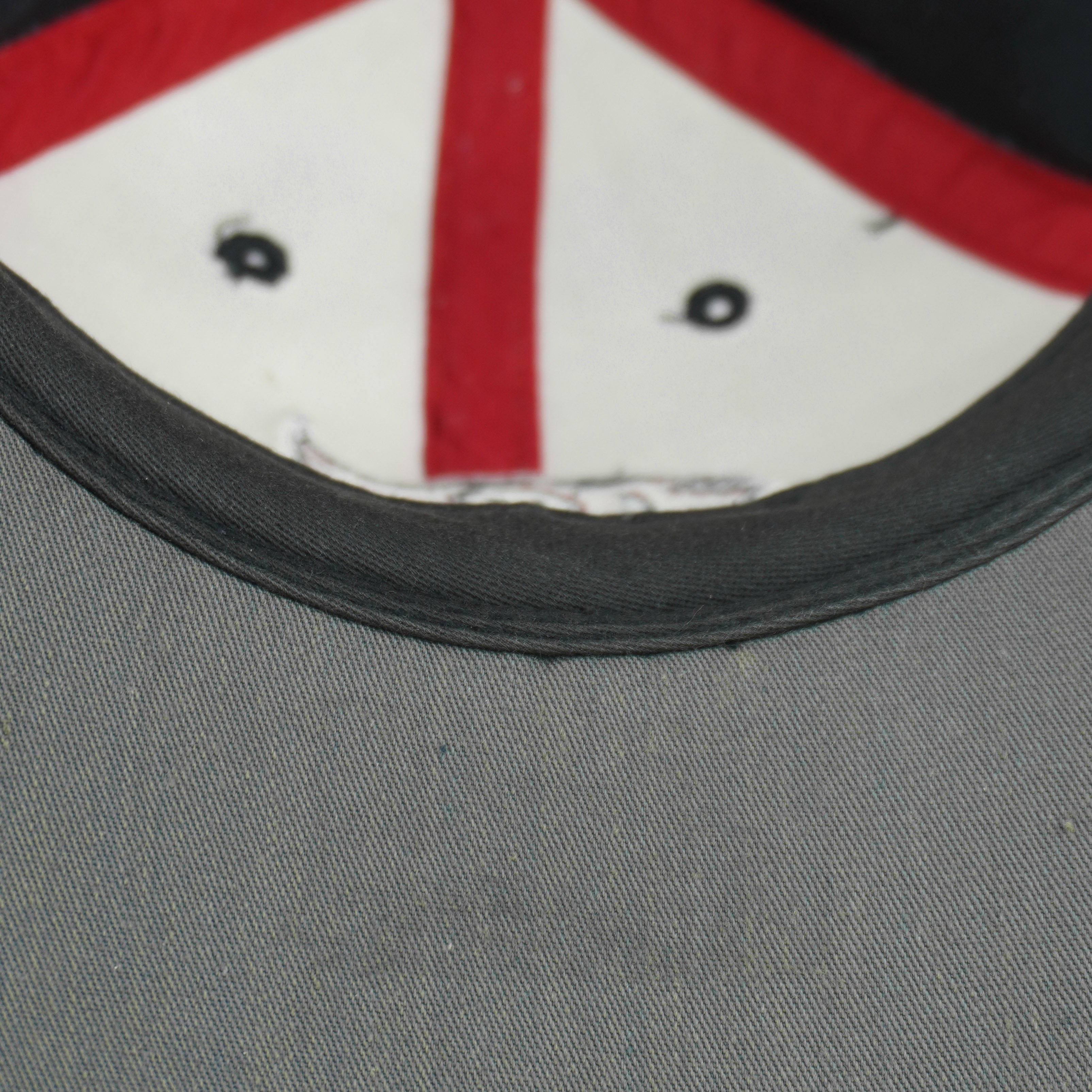 Small mark visible on the gray underside of the brim