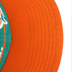 Small dark marks visible on the orange brim