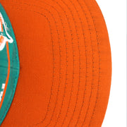 Small dark marks visible on the orange brim