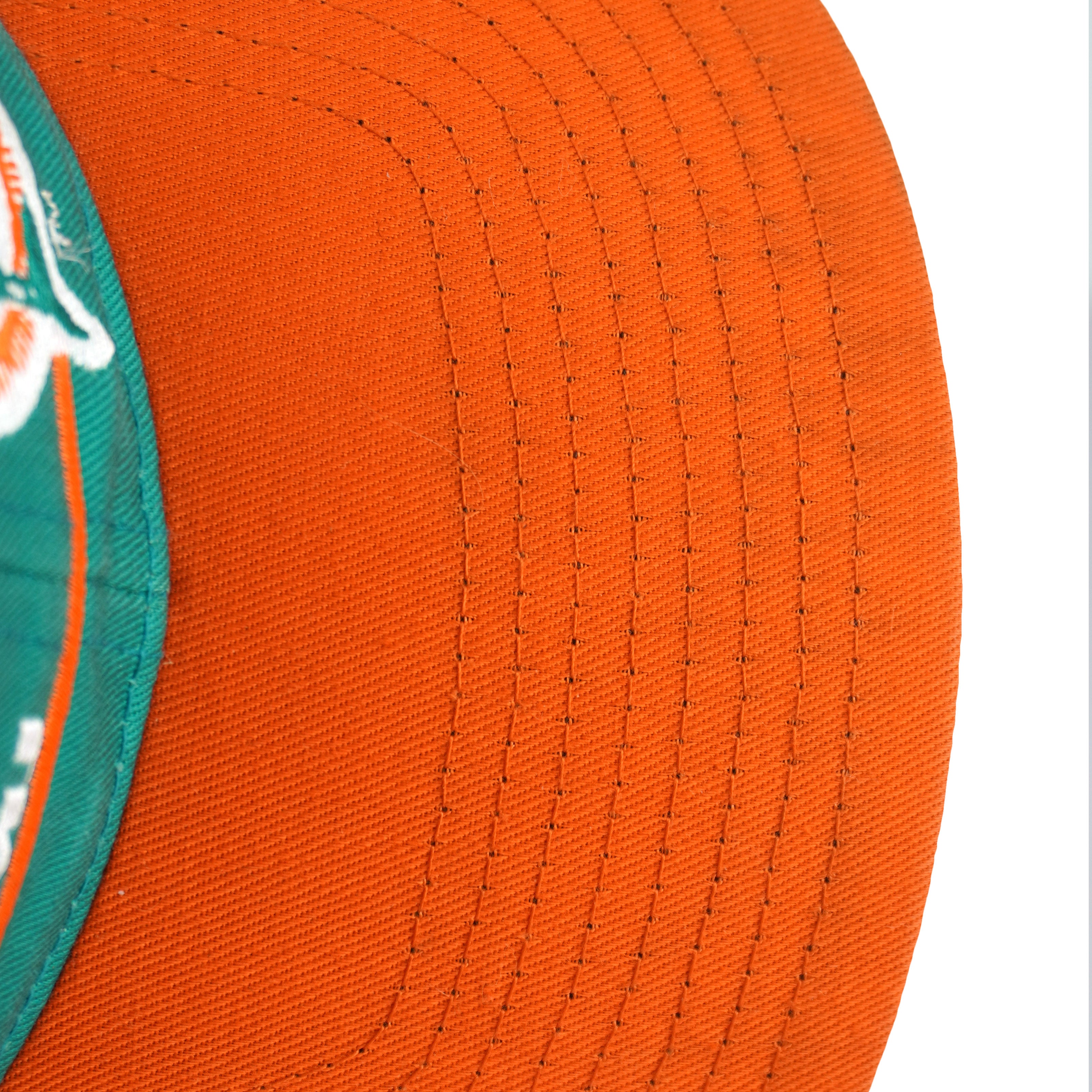 Small dark marks visible on the orange brim