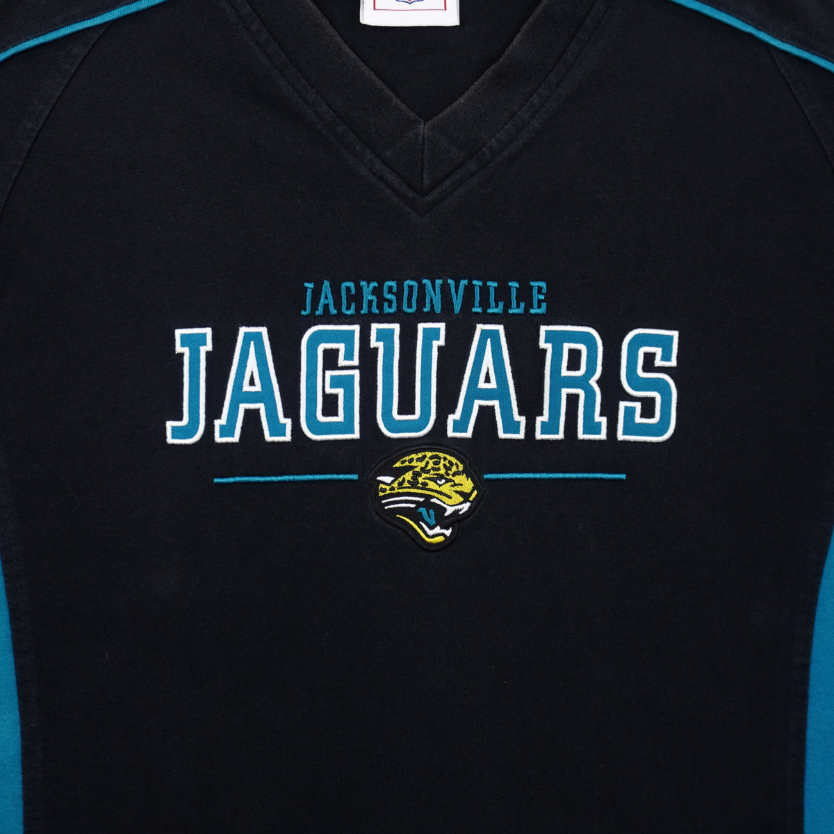 Embroidered Jaguars lettering beneath the V-shaped neckline