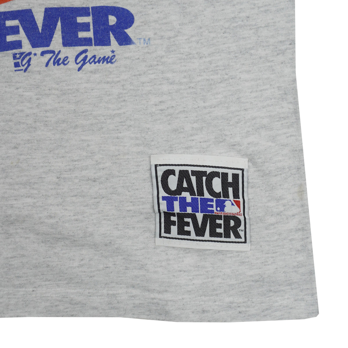 Catch the Fever patch near the gray shirt hem