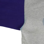 Blue sleeve seam meeting the gray body of the Mets shirt