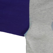 Blue sleeve seam meeting the gray body of the Mets shirt