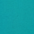 Small dark mark on the teal-green jersey fabric