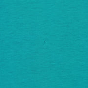 Small dark mark on the teal-green jersey fabric