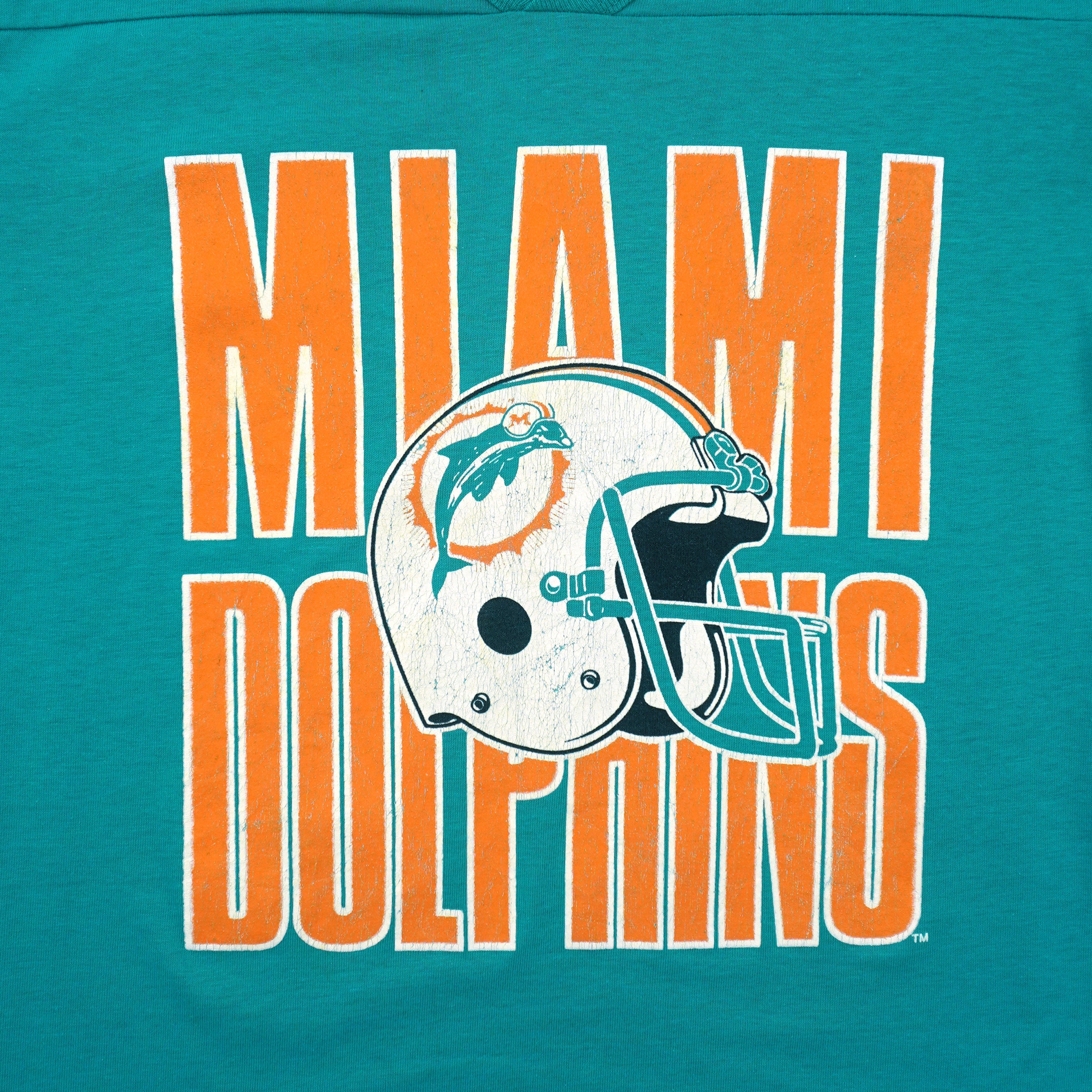 Close view of Miami Dolphins lettering and cracked helmet print