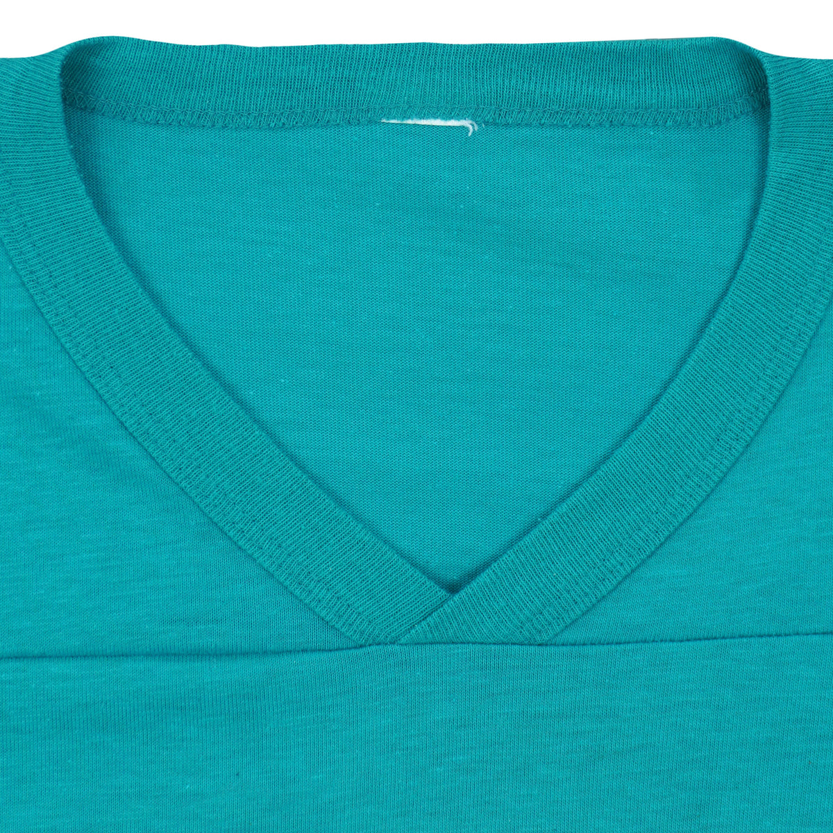 V-neck collar and removed label area of the Dolphins jersey