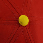 Small dark mark on the yellow top button