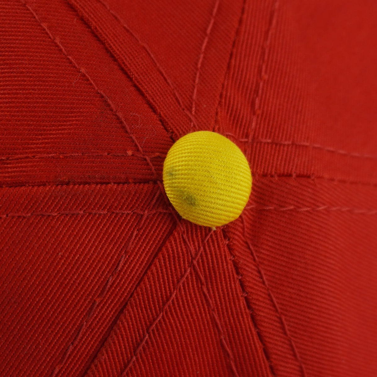 Small dark mark on the yellow top button