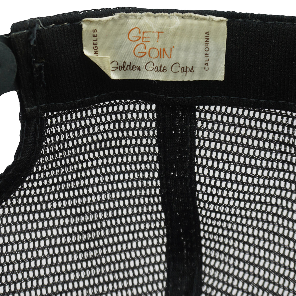 Get Goin Golden Gate Caps label inside the black trucker hat