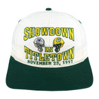 White and green Showdown in Titletown hat with Cowboys and Packers helmets