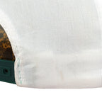 Small mark beside the rear opening of the white hat