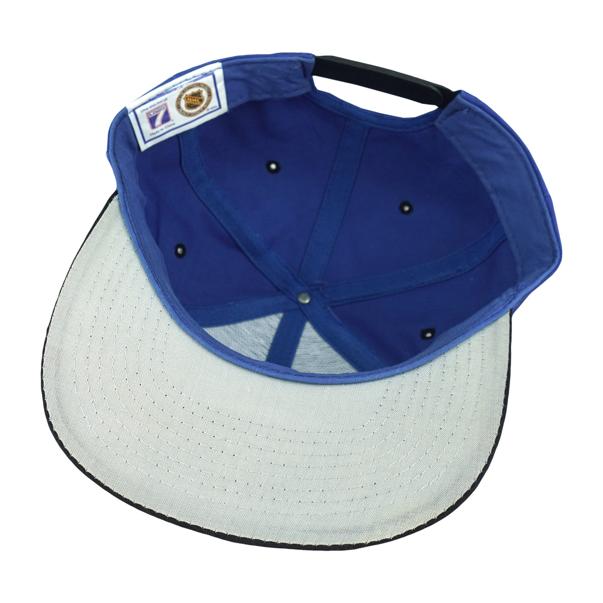 Interior and white underbrim view of the blue, black, and white Washington Capitals eagle-logo snapback cap