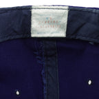 Close view of a faded white interior label inside the blue Seattle Mariners snapback cap