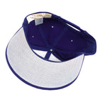 Interior and white underbrim view of the purple and white Milwaukee Brewers glove-logo snapback cap