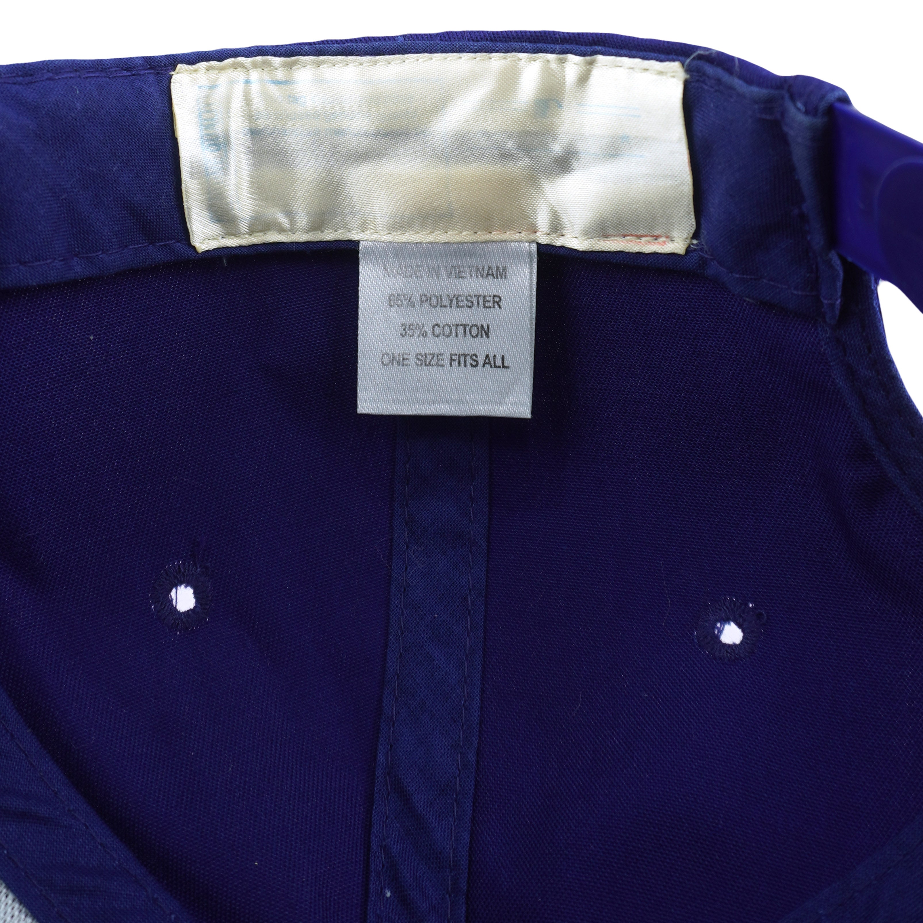 Faded care label detail of the purple and white Milwaukee Brewers glove-logo snapback cap