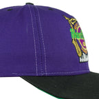 Side stitching and crown detail of the purple, black, and green Hard Rock New Orleans Mardi Gras snapback cap