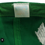 Faded inner brand label detail of the green and black Philadelphia Eagles wraparound-word snapback cap