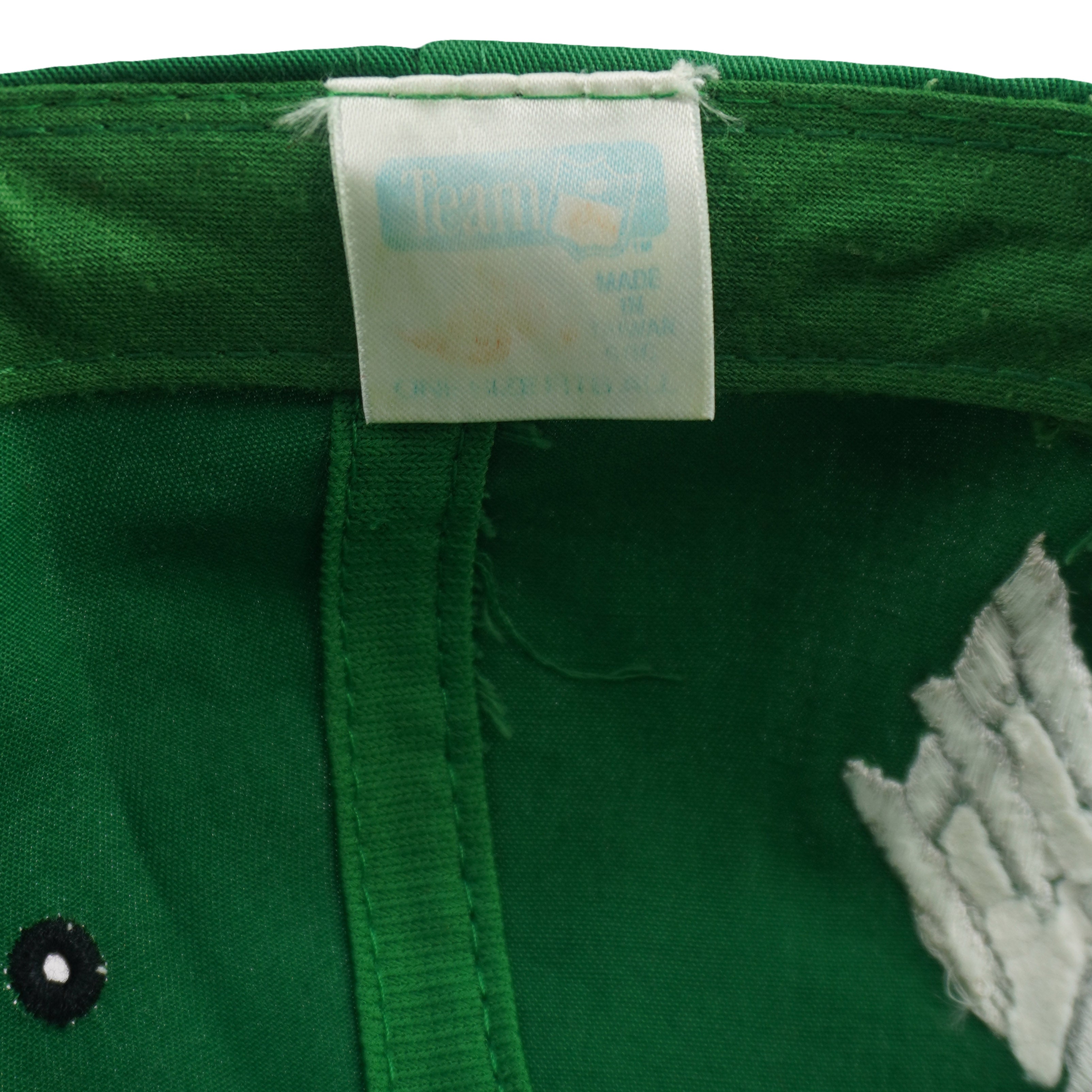 Faded inner brand label detail of the green and black Philadelphia Eagles wraparound-word snapback cap